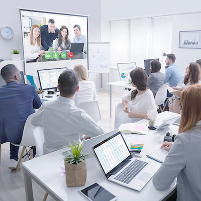 People sitting in a conference room with a video call
